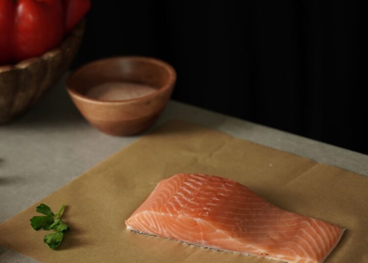 Salmón fresco rico en omega 3 preparado en una bandeja con verduras