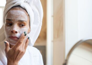 Mujer aplicándose una crema con ceramidas en el rostro durante su rutina facial